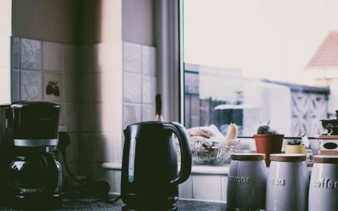 A modern coffee maker sitting on a clean kitchen countertop
