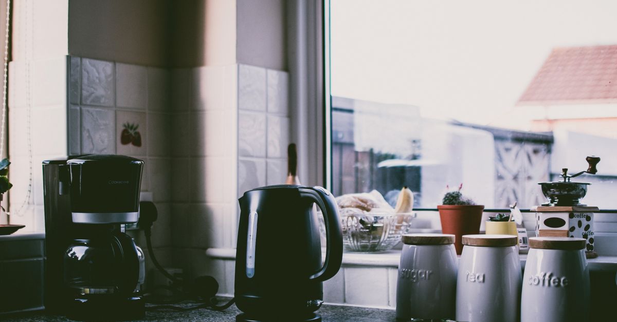 A modern coffee maker sitting on a clean kitchen countertop