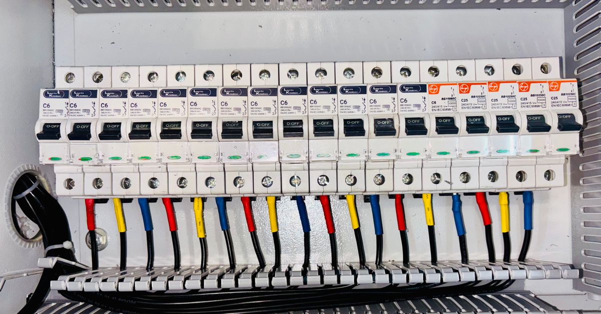 Open electrical breaker panel in an apartment hallway