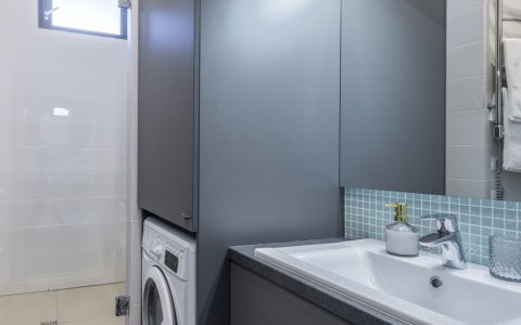 Compact portable washing machine connected to a standard apartment kitchen sink