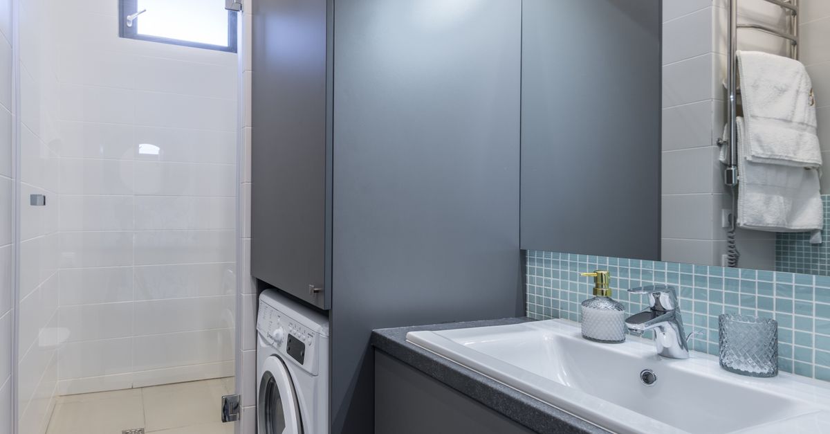 Compact portable washing machine connected to a standard apartment kitchen sink