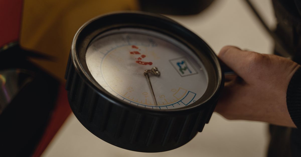 Close-up of air compressor pressure gauges and regulator