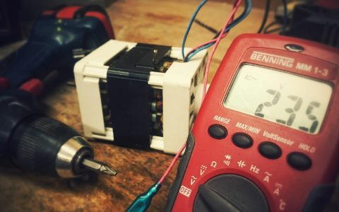 Close-up of a digital multimeter screen displaying voltage measurements during an electrical check.