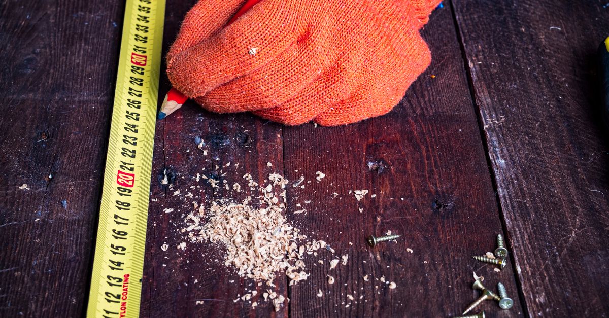 Close-up of a workshop workbench with layout tools and a precision square.