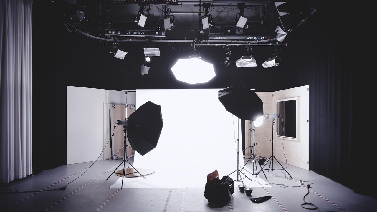 A technician testing electronic components on a studio lighting unit.