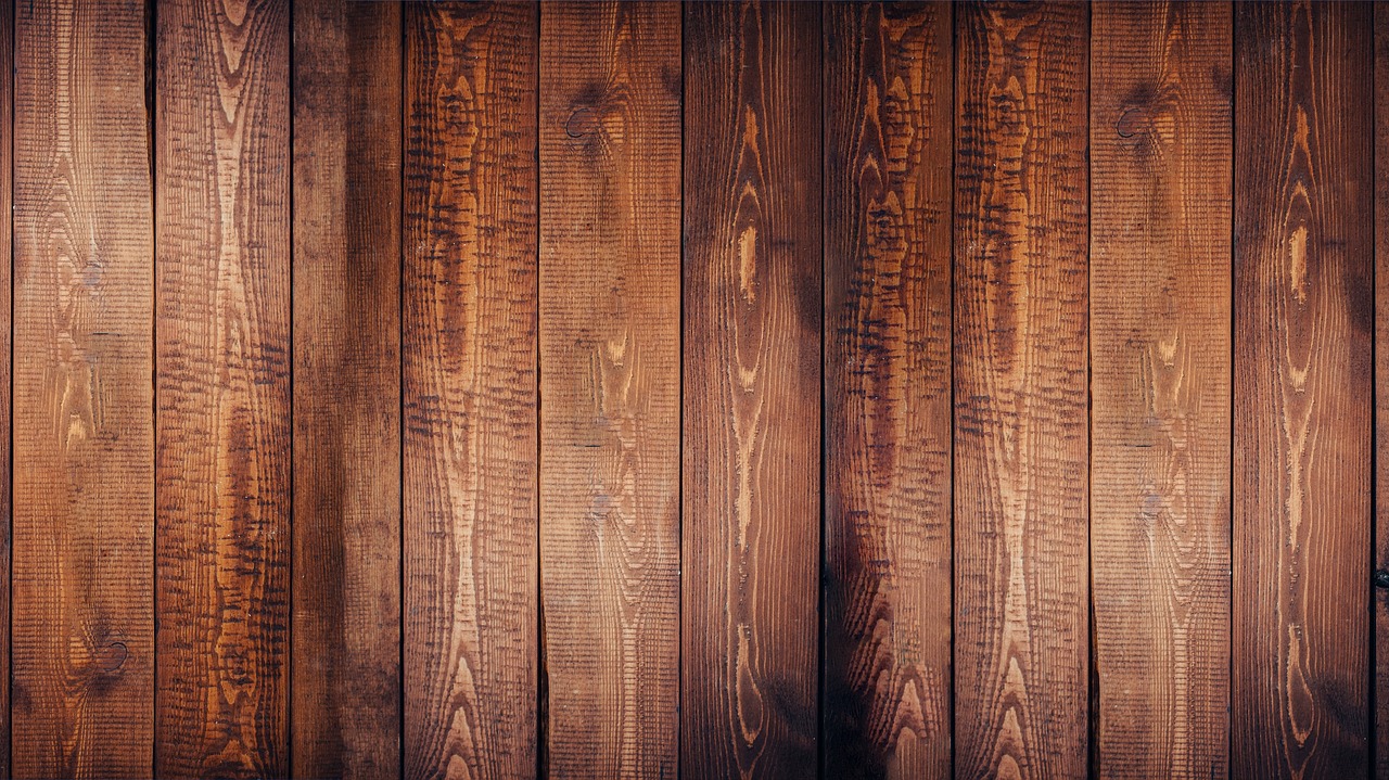 Close-up of a wooden wobble board on a home office floor.