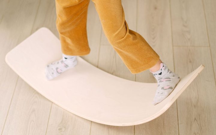 Remote worker using a standing desk balance board in a home office.