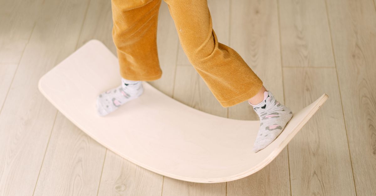 Remote worker using a standing desk balance board in a home office.