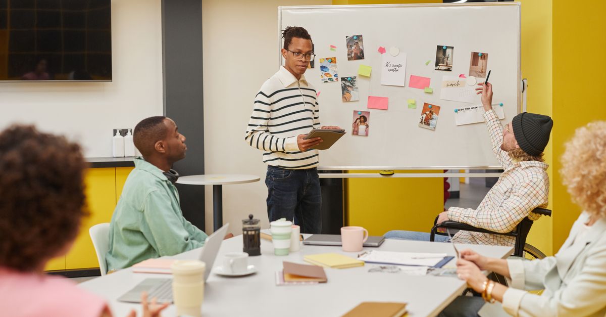 Product team collaborating around a whiteboard with sticky notes