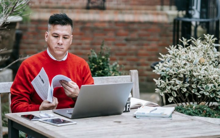 Remote professional reviewing system analytics on a laptop at a home desk