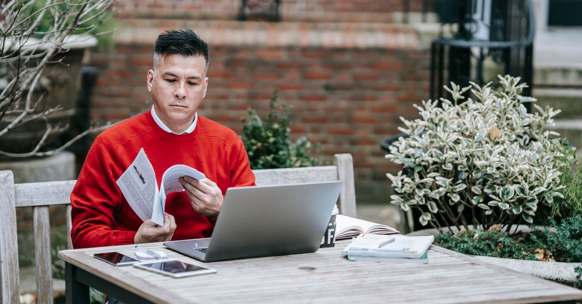 Remote professional reviewing system analytics on a laptop at a home desk
