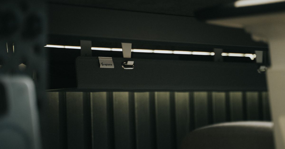 Clean under-desk cable organization with mounted power strips and backup hardware.