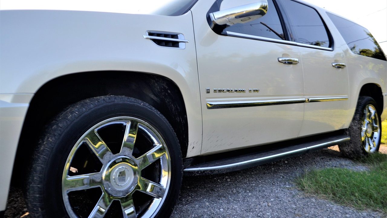 Pre-owned full-size SUV parked in a residential driveway
