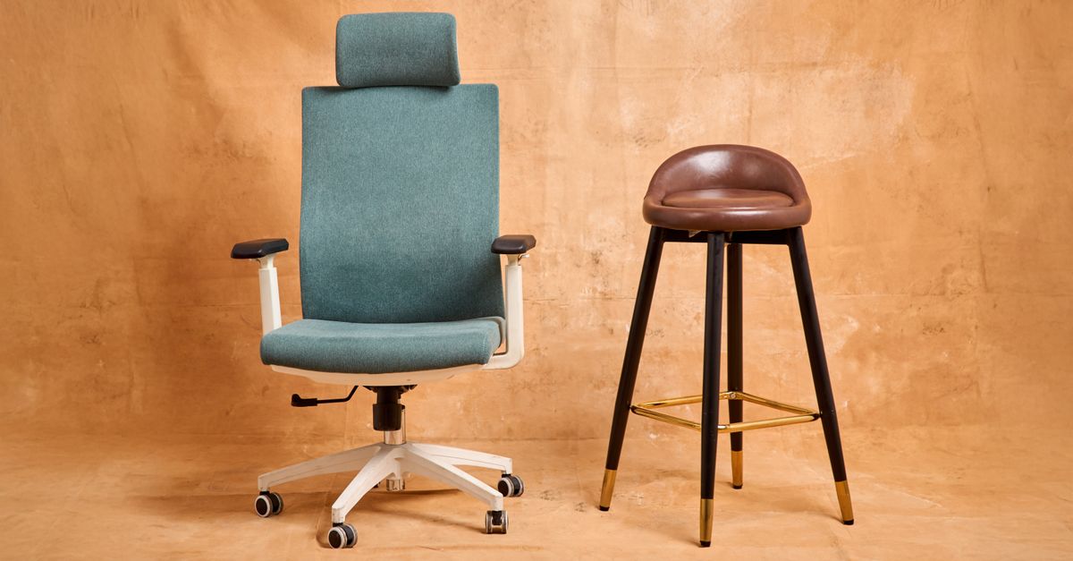 Person adjusting their office chair armrest height to match the desk surface.