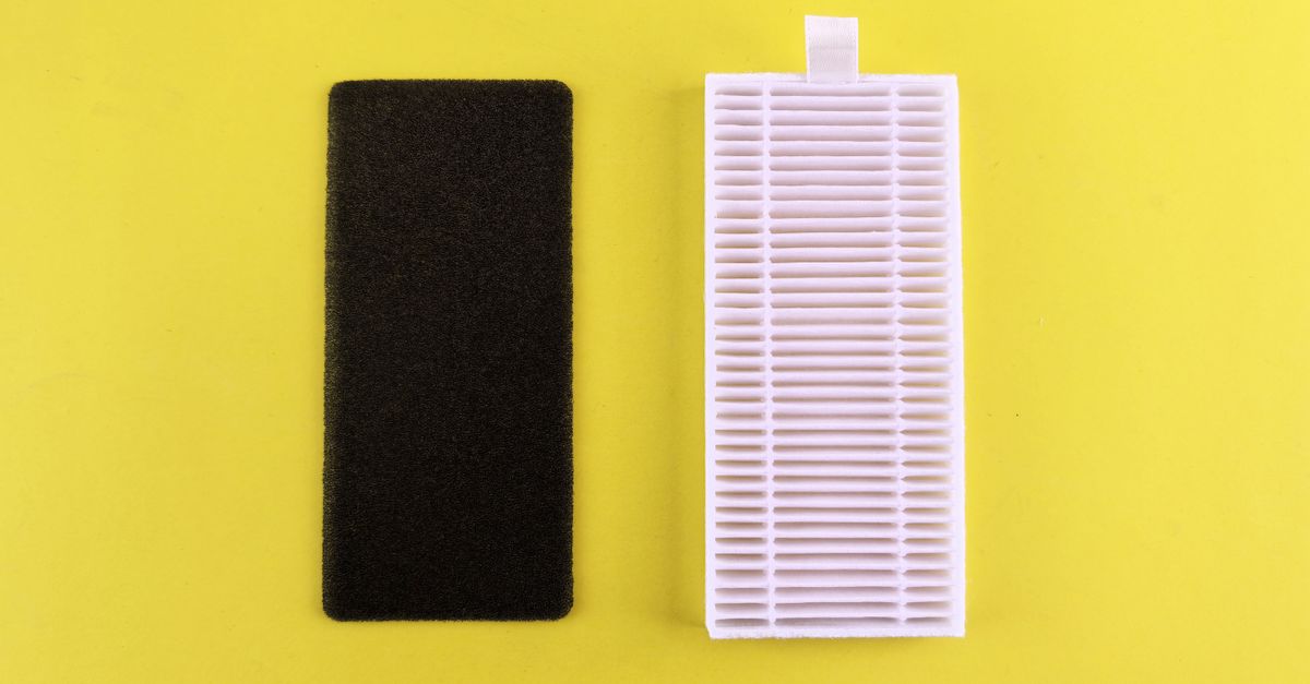 Close-up of hands cleaning mineral scale off a humidifier wick filter